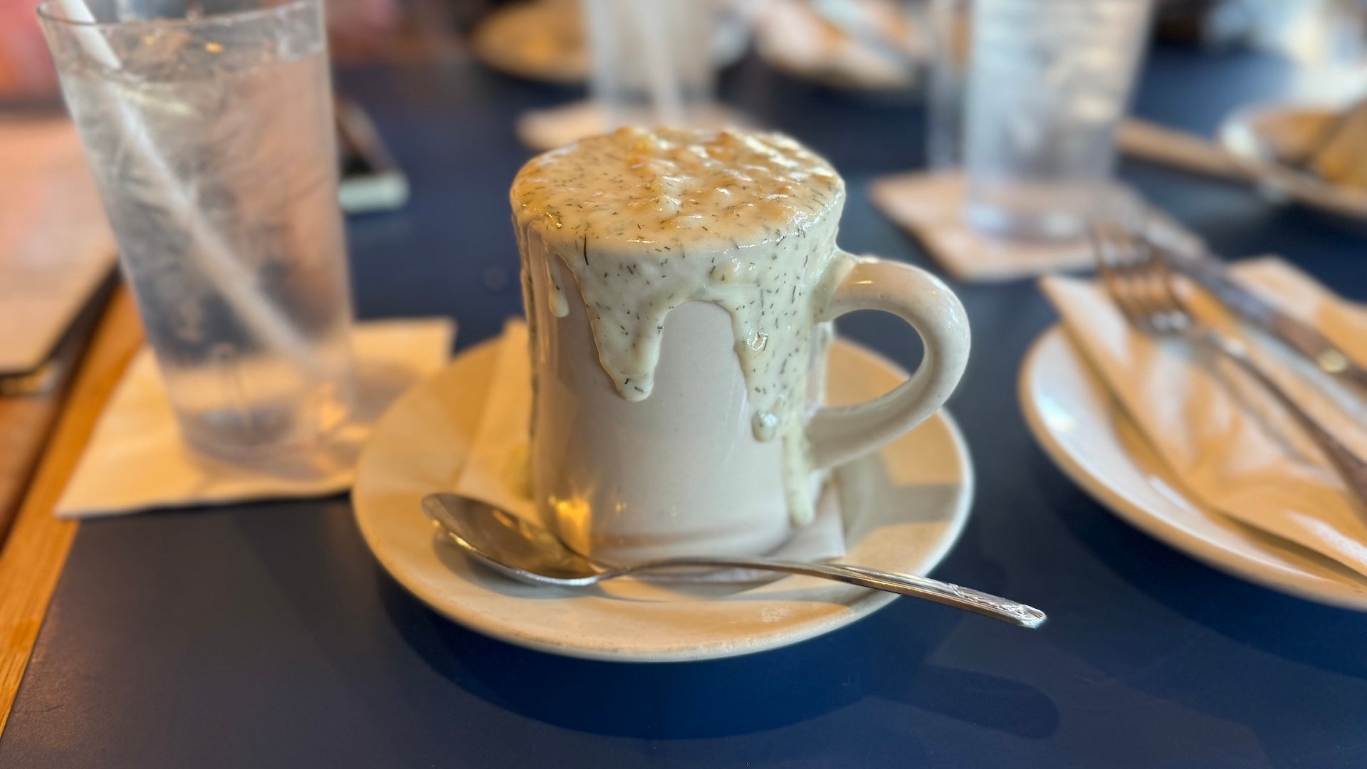 White cup overfilled with clam chowder